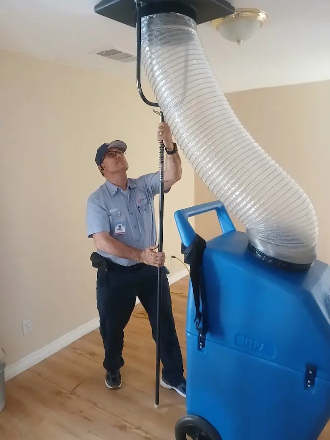 Furnace Tune-Up technician using HEPA equipment in Harahan
